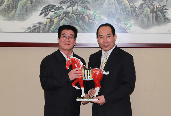   枣庄市委副书记、代市长李峰（左）向中非贸促会执行会长秦金玮（右）赠送纪念品